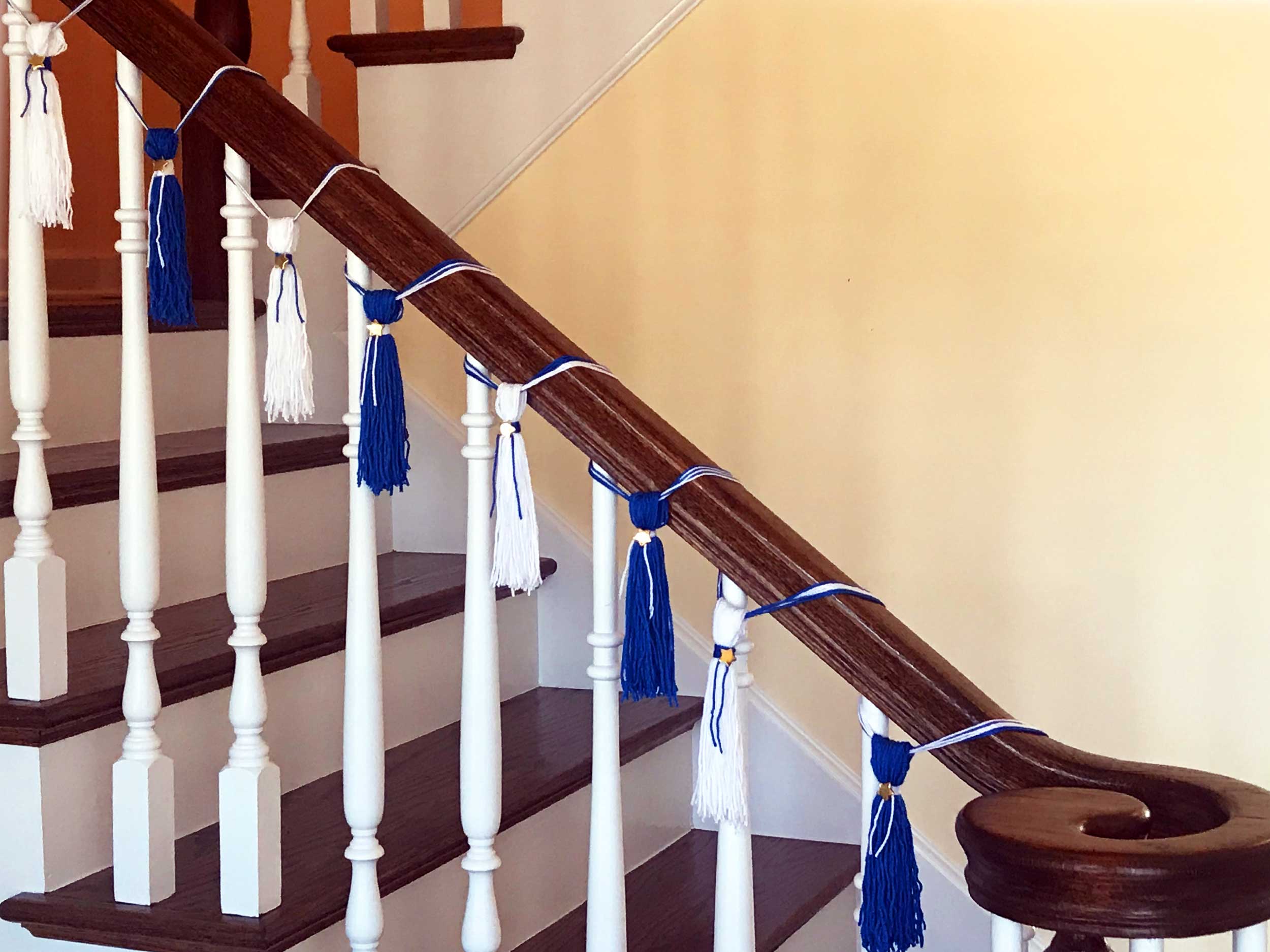 DIY Graduation Tassel Garland hanging from stair banister | OrnamentShop.com
