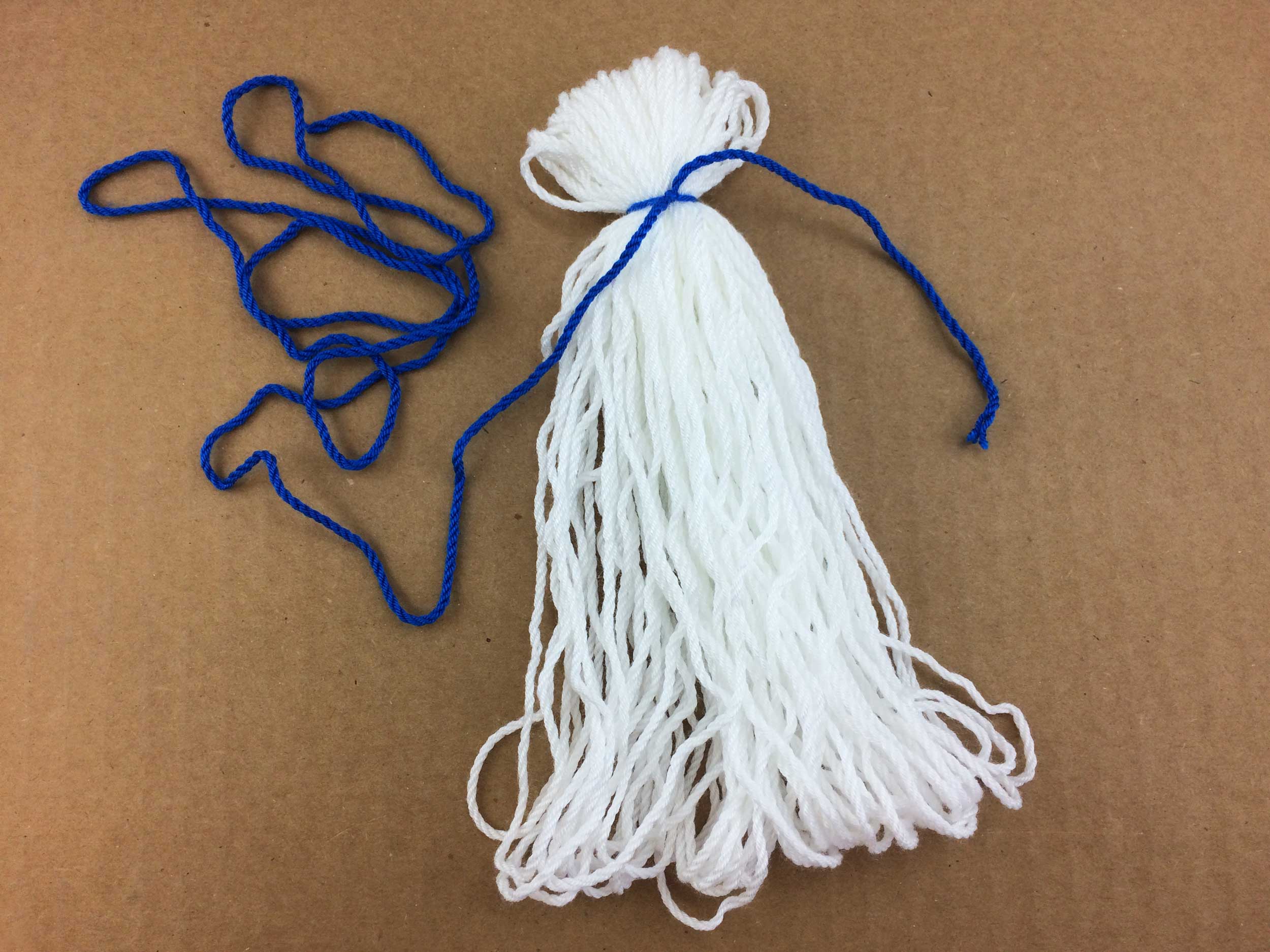 Remove yarn from DVD case and tie a knot in contrasting color | OrnamentShop.com