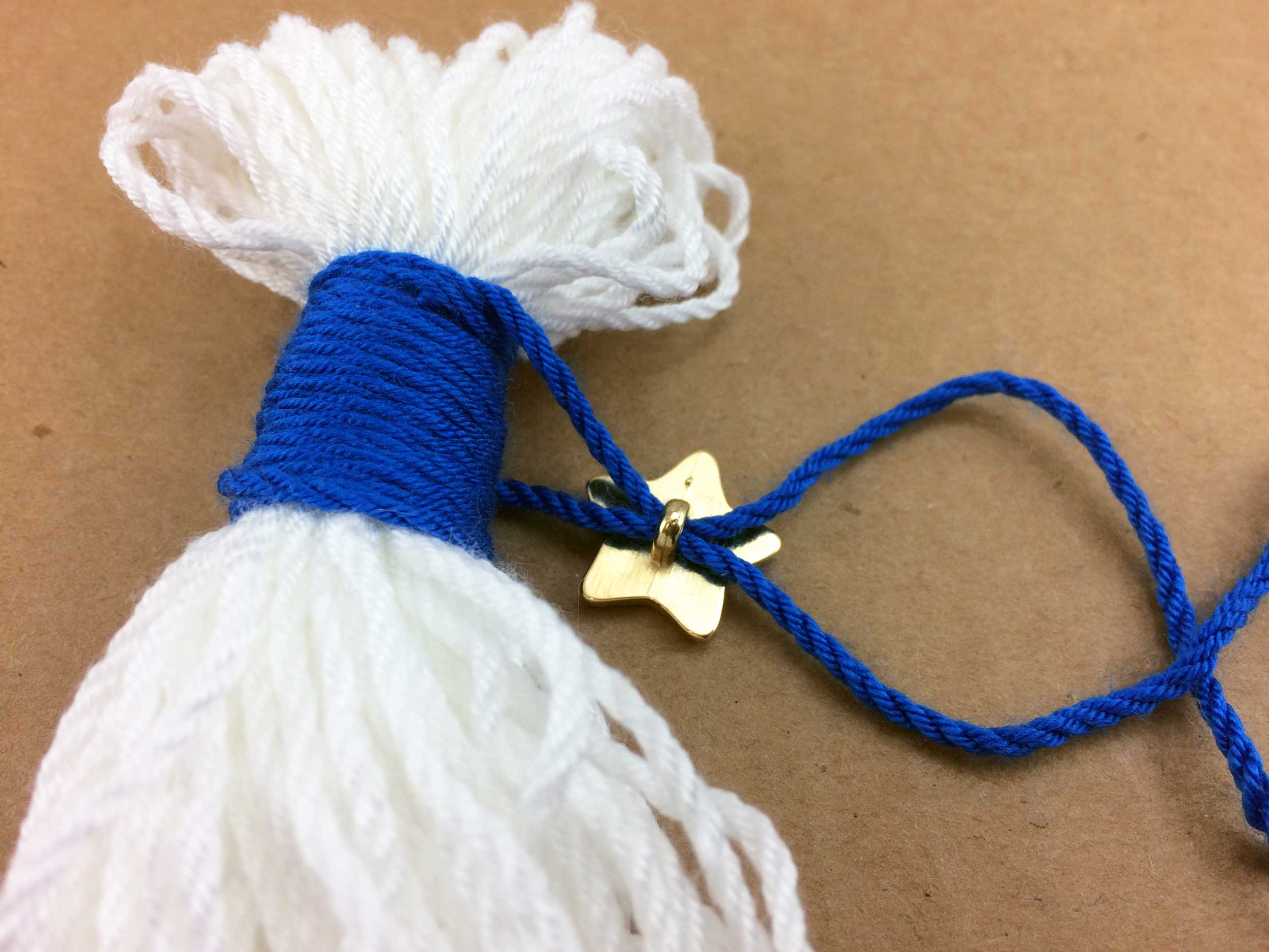 Thread Gold Star Button to contrasting color yarn | OrnamentShop.com