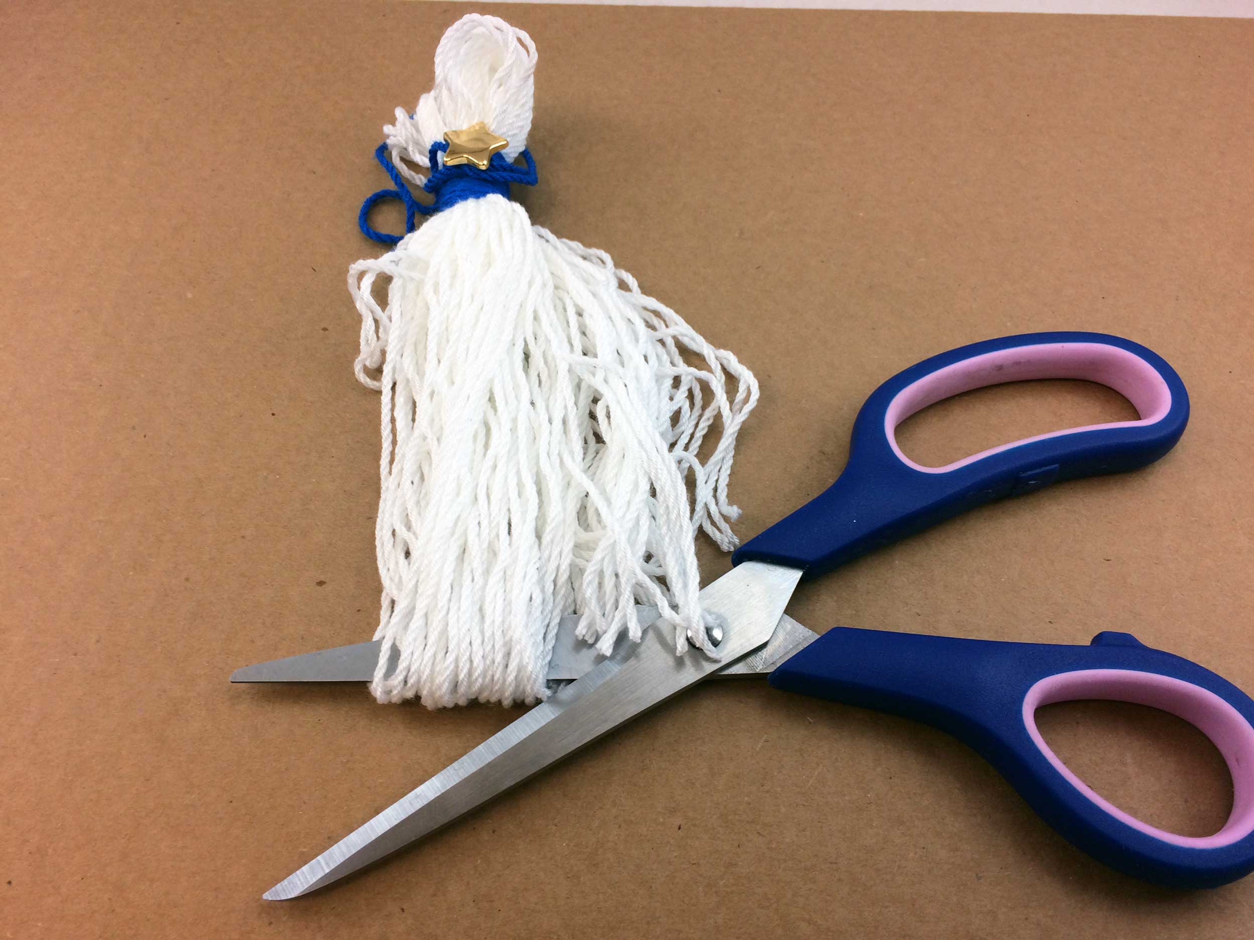 Cut bottom loops of DIY Graduation Tassel to create fringe | OrnamentShop.com