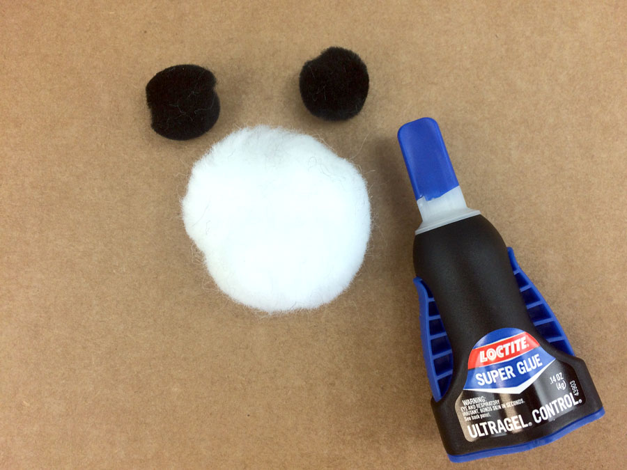 Glue small black pom pom ears onto white pom pom panda head | OrnamentShop.com
